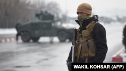 An Afghan soldier guards the site of an attack near the Marshal Fahim Military Academy in Kabul on January 29.