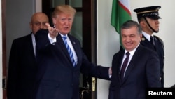 U.S. President Donald Trump greets Uzbekistan's President Shavkat Mirziyoev at the White House in Washington on May 16. 