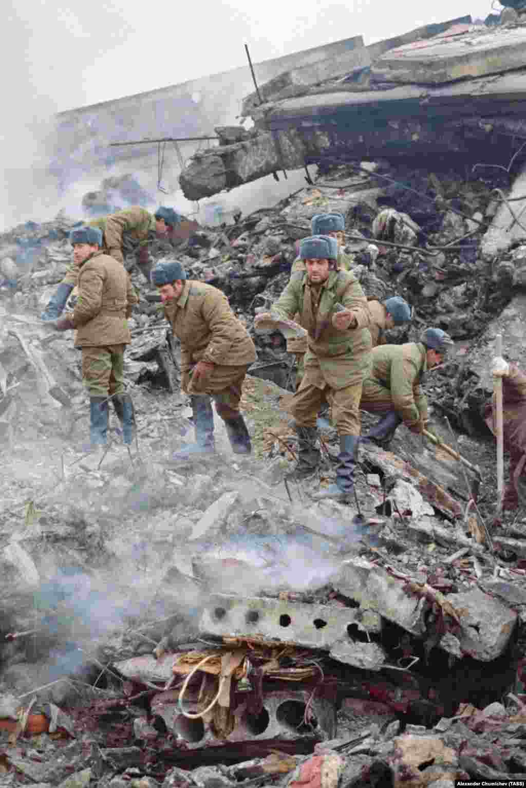 Soviet soldiers working to clear the piles of rubble. Gorbachev asked one interviewer, "Who is to blame for the fact that in the concrete blocks there is too little cement but more than enough sand? This means the cement was stolen. By whom?"