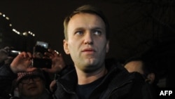 Anti-Kremlin blogger Aleksei Navalny speaks to journalists and supporters outside a police station in Moscow in December.