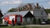 A Polish police officer attends the scene as firefighters work on the destroyed roof of a house on September 10 after Russian drones violated Polish airspace during an attack on Ukraine. Some of the drones were shot down by Poland with backing from its NATO allies. 