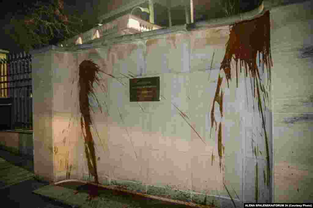 The wall outside the Russian Embassy in Prague was sprayed with ketchup overnight on April 18 during a protest staged to call attention to the deaths of the two people in the 2014 explosion. Moscow warned about its response to the expulsions.&nbsp;"Prague is well aware of what comes after such hocus-pocus," Foreign Ministry spokeswoman Maria Zakharova said.