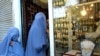 Afghan women wearing burqas enter a jewellery shop in the western Afghan city of Herat.