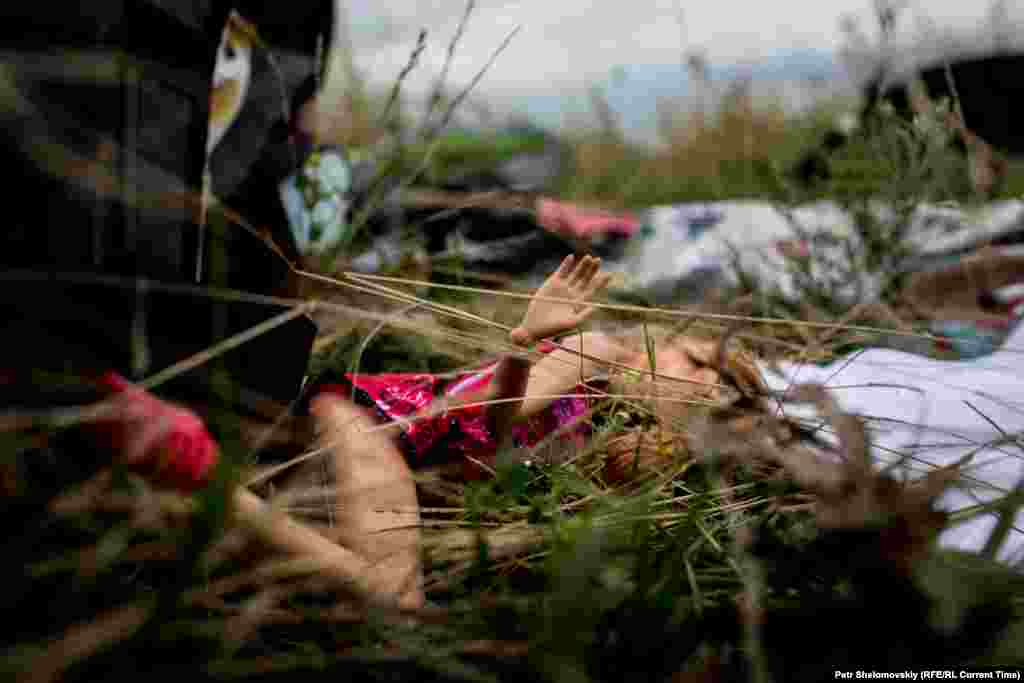 A child's doll is seen among the victims' belongings scattered near the village of Grabovo.