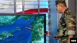  A TV grab shows a Syrian military spokesman explaining on a map on June 23 that resulted in a Turkish fighter being shot down. 