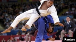 Betkili Shukvani (in blue) was eliminated in just the second round by Frenchman Sofiane Milous.