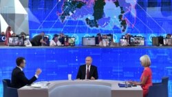 Russian President Vladimir Putin (center) holds his annual televised phone-in with the nation in Moscow on June 20.