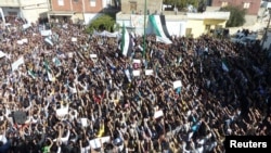 Syrian antiregime protesters gather in Hula, near the city of Homs