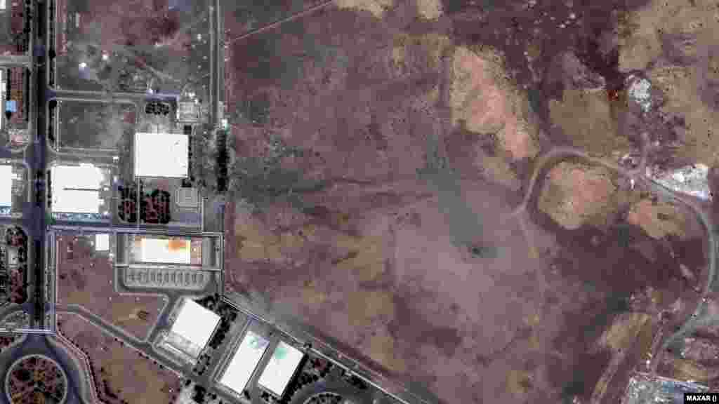A Maxar satellite image from June 22 shows a crater at Iran's Natanz Enrichment Facility following US air strikes. On June 24, the crater was covered with dirt.