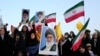 Iranian protesters hold their country's flags and posters of Khamenei in an anti-US and anti-Israeli rally in Tehran, June 24