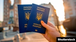 Generic – Hands holding Ukrainian abroad biometric passport