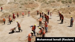 FILE: Laborers work on trenches on a hill to help improve the capital Kabul's water supply, amid the coronavirus disease (COVID-19) outbreak in June.