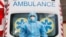 UKRAINE -- A medical worker wearing protective gear stands next to an ambulance outside a hospital for patients infected with the coronavirus disease (COVID-19) in Kyiv, November 24, 2020