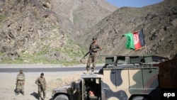 Afghan army soldiers stand guard on a roadside in Kabul in April.