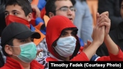 Armenia football fans wear masks to protect against swine flu in Yerevan.
