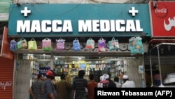 People line up at a pharmacy following the announcement to lock down Sindh Province amid concerns over the spread of the coronavirus, in Karachi, on March 22.