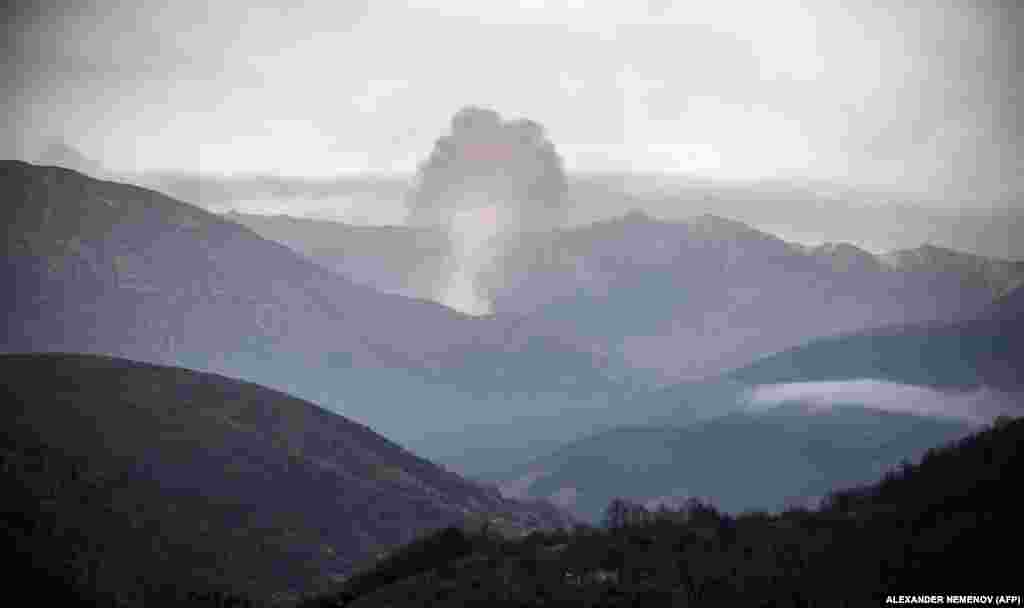 Smoke rises from buildings set ablaze in the Karvachar/Kalbacar district of Azerbaijan as ethnic Armenians leave the area.