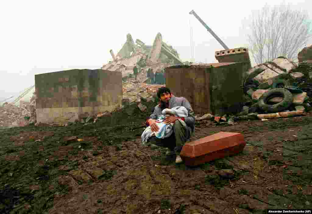 A man holds the body of his dead child in Gyumri.&nbsp;The quake lasted just 20 seconds, with a magnitude of 6.8, but the dust cleared to scenes of utter devastation.&nbsp;