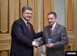 Президент України Петро Порошенко (ліворуч) вручає паспорт громадянина України Мішелю Терещенку. Київ, 21 березня 2015 року