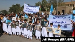 Afghans attend a rally in Herat to support the Doha peace talks between the Taliban and the Afghan government on September 21.