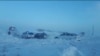 Боран кезінде қар басқан жолдағы автокөліктер (көрнекі сурет)