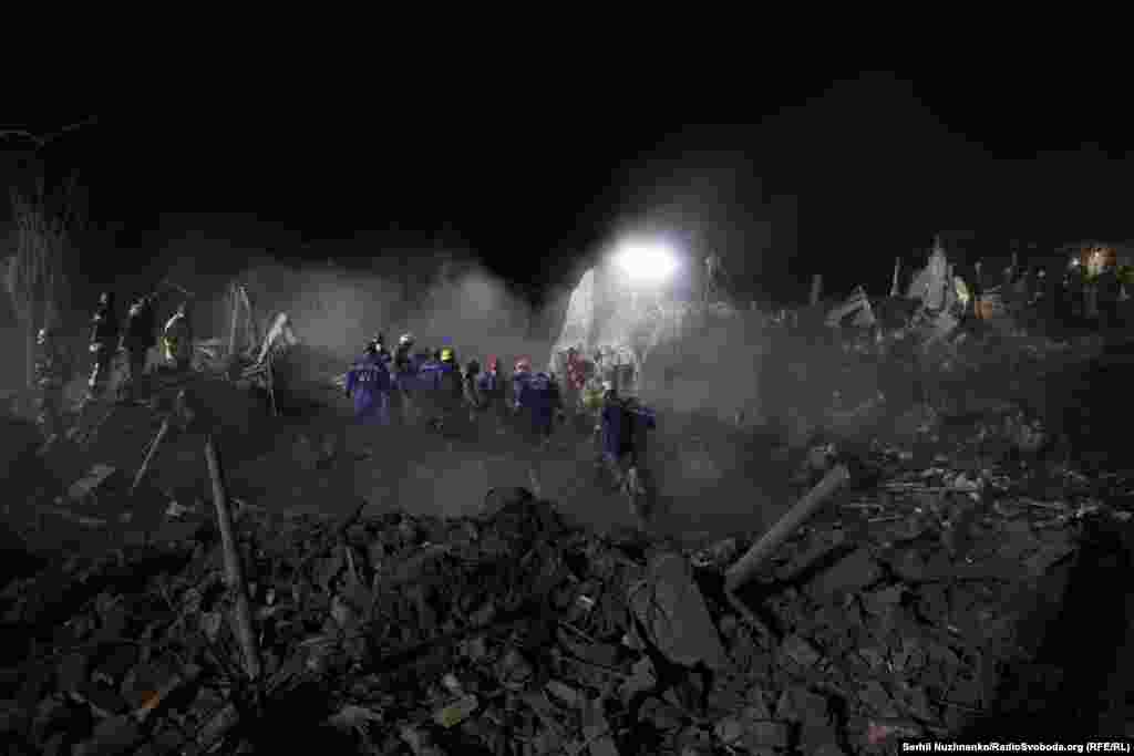 Rescuers search the rubble of an apartment building that was flattened in the Russian strike on Kyiv.