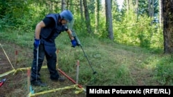 A deminer looks for buried ordnance on Trebevic mountain near Sarajevo in September. Years of harsh weather conditions have muddled what few maps authorities have of mined areas.