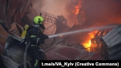 Firefighters work at the site of an office building hit by a Russian missile strike in Kyiv early on April 6.