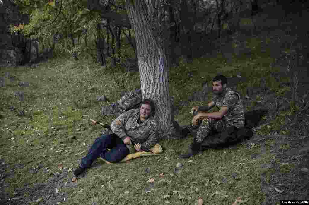 Armed volunteers relax at an undisclosed location south of Stepanakert. &nbsp; Armenia has a long history of armed volunteers signing up to fight in the country's wars.