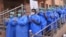 FILE: Hospital staff pray before begging their work shift outside a hospital for coronavirus infected patients in the southwestern city of Quetta on March 26.