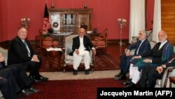 FILE: U.S. Secretary of State Mike Pompeo, left, with Afghan President Ashraf Ghani, Afghan Chief Executive Officer Abdullah Abdullah, and former Afghan President Hamid Karzai, right, at the Presidential Palace in Kabul in June 2019.