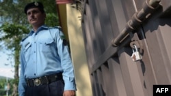 A Pakistani policeman outside the office of international aid group Save the Children in Islamabad.