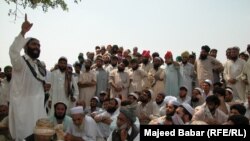 FILE: In the absence of state courts, parties to a conflict often make heated arguments while making their case before a tribal jirga or council. Here, the residents of the town of Bara in the Khyber tribal district debate the fate of minority Sikhs threatened by a fanatical cleric in 2002.