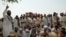 FILE: In the absence of state courts, parties to a conflict often make heated arguments while making their case before a tribal jirga or council. Here, the residents of the town of Bara in the Khyber tribal district debate the fate of minority Sikhs threatened by a fanatical cleric in 2002.
