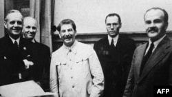 German Foreign Minister Joachim Von Ribbentrop (left), Joseph Stalin (center), and his foreign minister, Vyacheslav Molotov (right), in the Kremlin on August 23, 1939.
