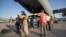 Evacuees from Afghanistan leave a German Air Force plane in Tashkent on August 26.