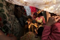 Geeta, 17, a Hindu refugee from Pakistan, reacts during a "haldi" ceremony before getting married at a Hindu refugee settlement situated in a woodland area in New Delhi.
