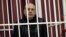 Fashion designer Sasha Varlamau attends the opening court hearing during his trial in Minsk on February 4.