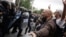 Spanish police confront people outside a polling station for the banned independence referendum in Tarragona, Spain, on October 1.