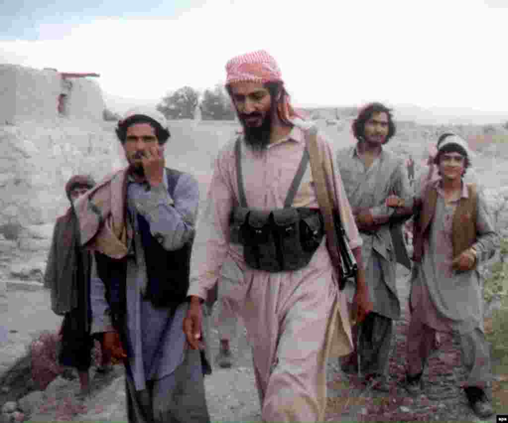 Osama bin Laden walks with Afghanis in the Jalalabad region in 1989.