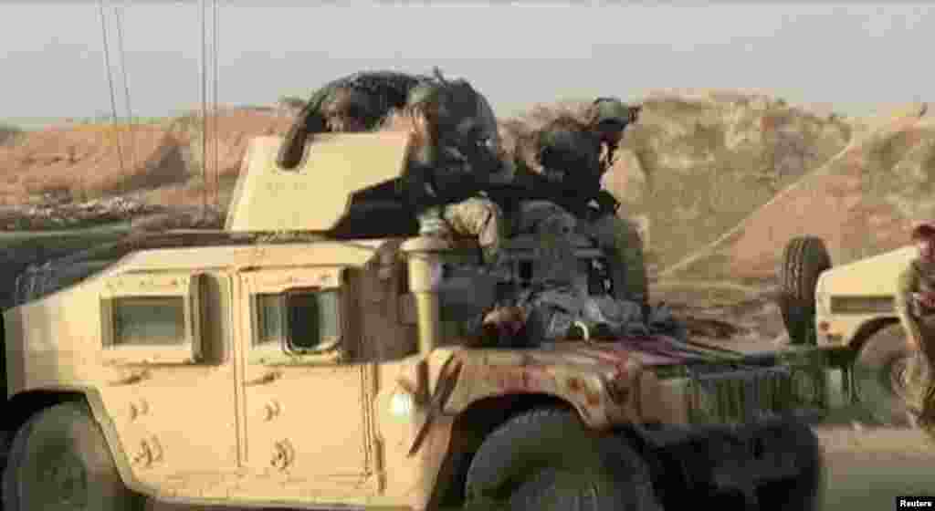 A Humvee with the body of a dead Taliban fighter on its hood on July 7 after fighting around the northern city of Kunduz.&nbsp;