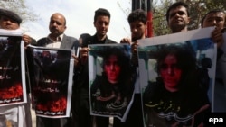 Afghan civil-society activists hold placards during a protest against the killing of Farkhanda in Herat on March 23.