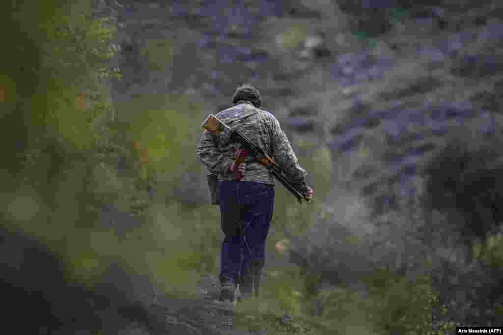 A volunteer fighter strolls near a village south of Stepanakert. &nbsp; In early October, a volunteer fighter told AFP: "We are a small nation and we don't have any other alternative but to win. This is why everyone needs to fight."