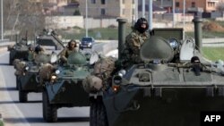Russian armored vehicles on the road between Simferopol and Sevastopol, in Ukraine's Crimea, on March 17