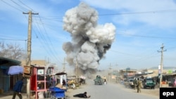 Smoke billows from the scene of a suicide bomb blast that targeted the police headquarters in the northeastern city of Kunduz in February.