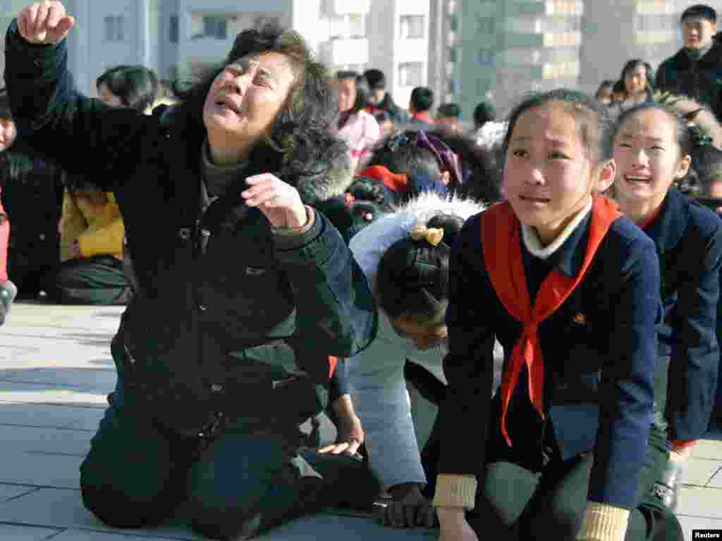 North Koreans react as they mourn Kim's death in Pyongyang on December 19.