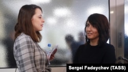 Dozhd TV producer Daria Zhuk (left) and BBC journalist Farida Rustamova arrive at the State Duma's Ethics Commission meeting in Moscow on March 21.