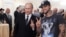 Russian Prime Minister Vladimir Putin (left) poses for a photo with rapper Timati during a meeting with his campaign activists in Moscow in March 2012.