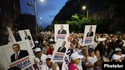 Armenia - Demonstrators hold pictures of jailed Russian-Armenian billionaire Samvel Karapetian, Yerevan, July 4, 2025.