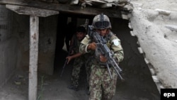 Members of the Afghan security forces take position during an operation against the Islamic State in Khot district of Nangarhar Province, on July 26.